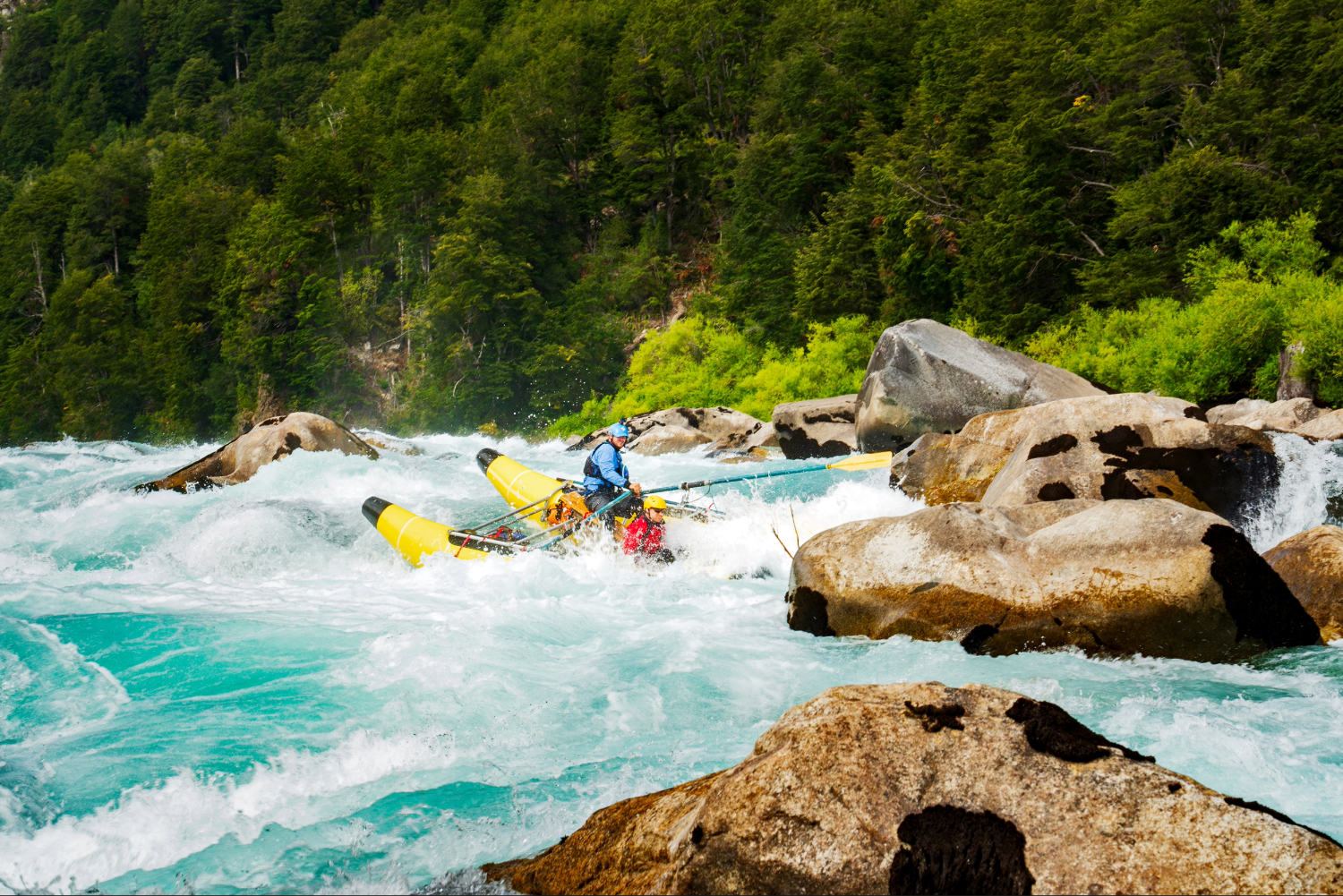 Safety cataraft navigating powerful rapids on the turquoise Futaleufú River in Patagonia