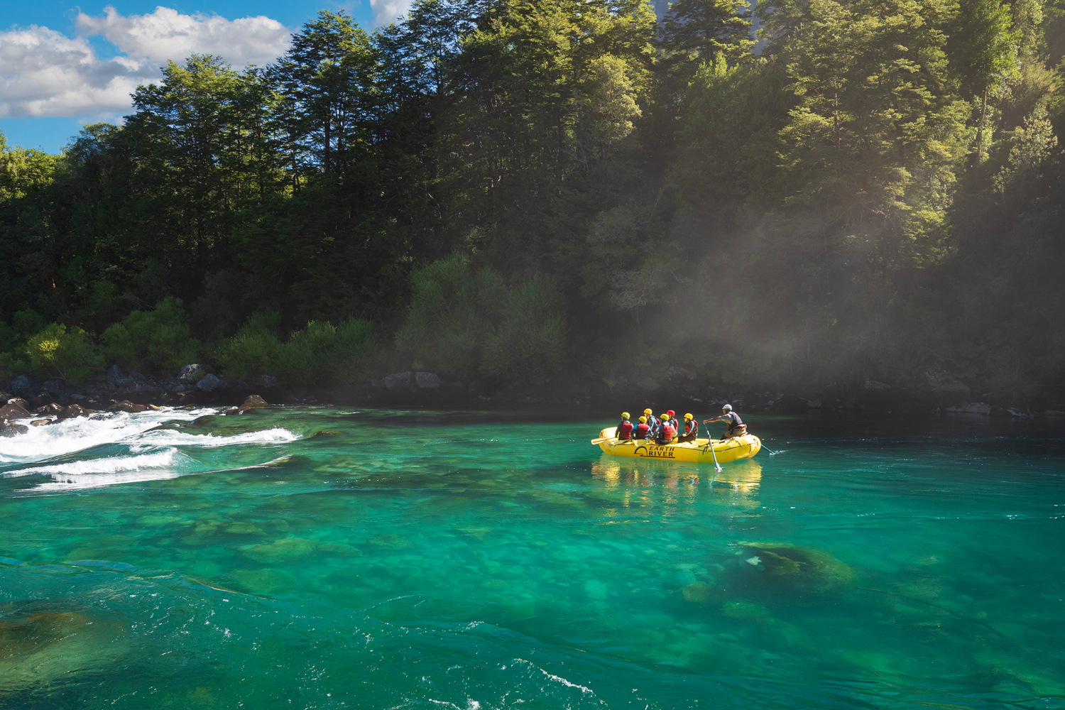 Raft floating through calm emerald waters on the Futaleufú River in Patagonia
